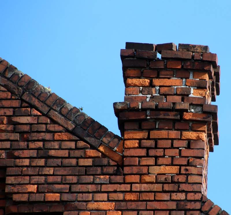 Signs Your Woodridge Home Needs a Chimney Inspection Damaged chimney on an Woodridge home showing cracks and missing mortar